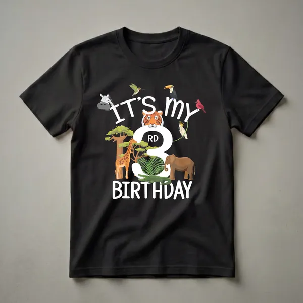 Black t-shirt featuring a colorful cartoon graphic for a 3rd birthday, with animals like a tiger, giraffe, elephant, crocodile, zebra, toucan, cockatoo, hummingbird, and cardinal.