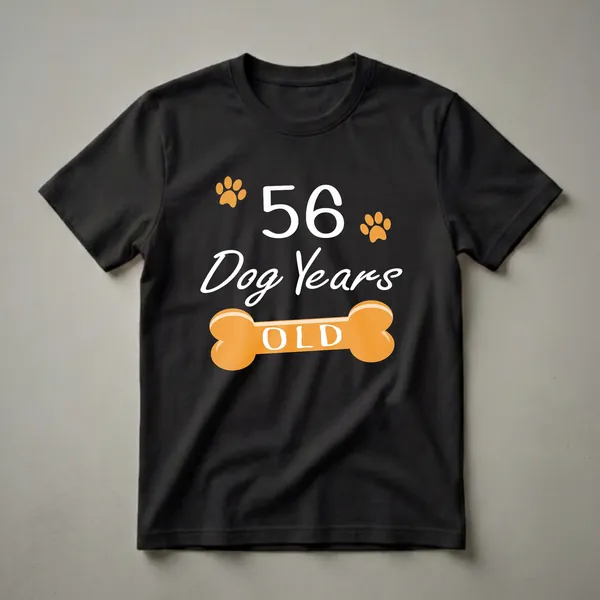 Black t-shirt with white text '56 Dog Years OLD', orange paw prints, and an orange dog bone graphic.