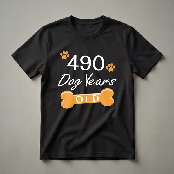 Black t-shirt with white text reading '490 Dog Years OLD' and orange paw prints and a dog bone graphic.