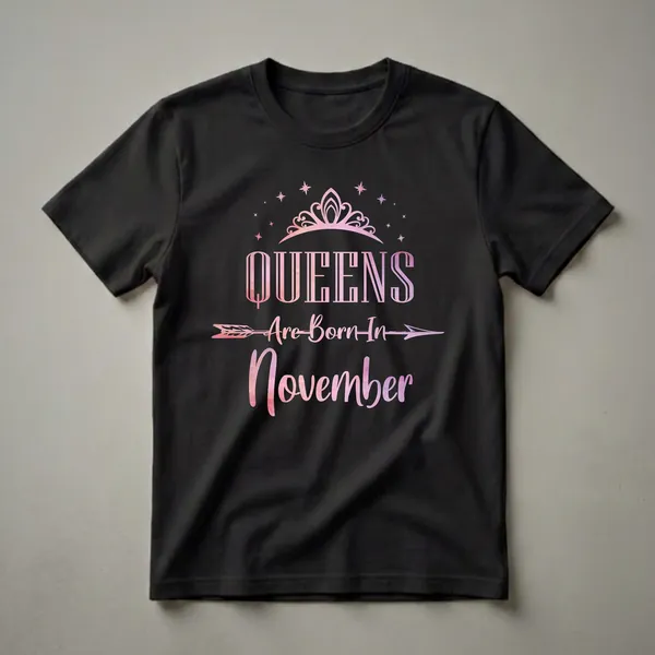 Black t-shirt with 'Queens Are Born In November' text in pink and purple watercolor style, topped with a crown and stars.
