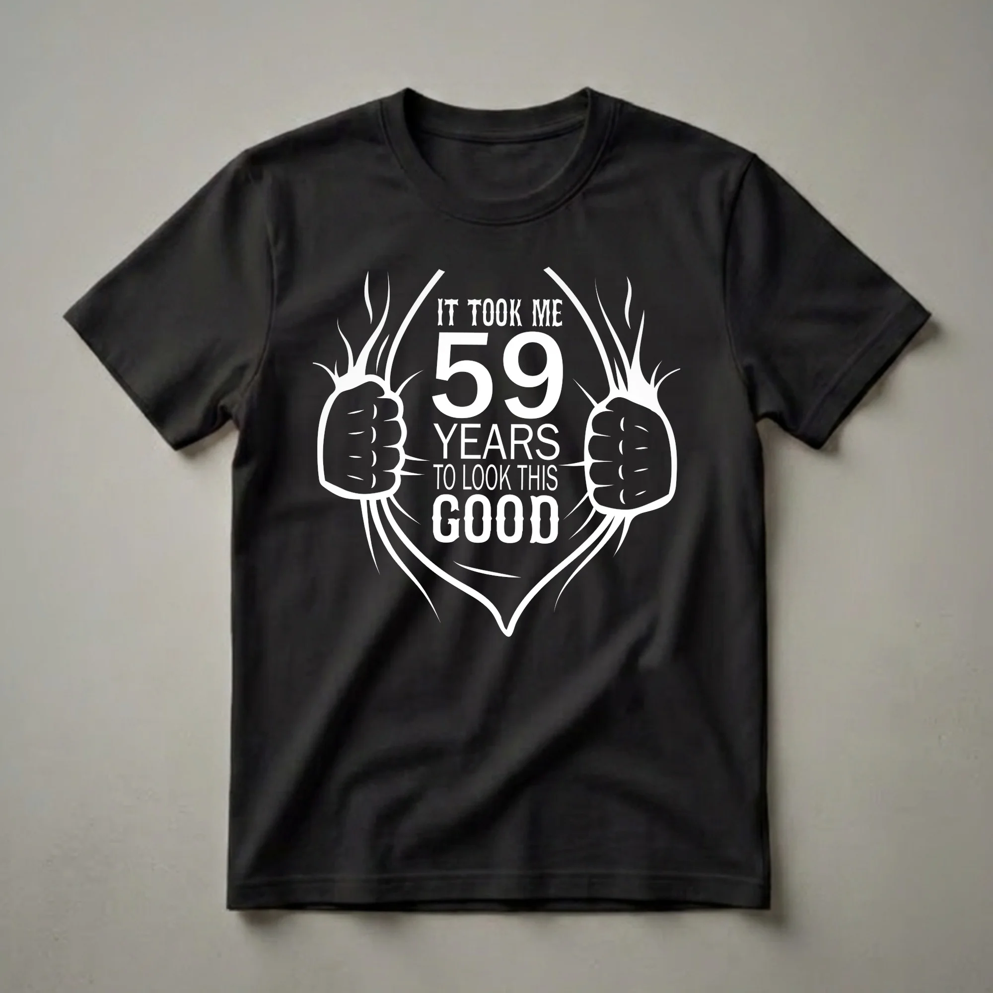 Black t-shirt with white graphic text that reads 'IT TOOK ME 59 YEARS TO LOOK THIS GOOD', designed to look like a ripped chest.