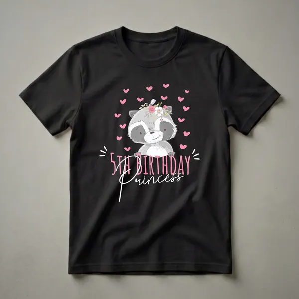 Black t-shirt featuring a cartoon raccoon wearing a floral crown, surrounded by pink hearts, with the text '5th Birthday Princess' in pink and white.