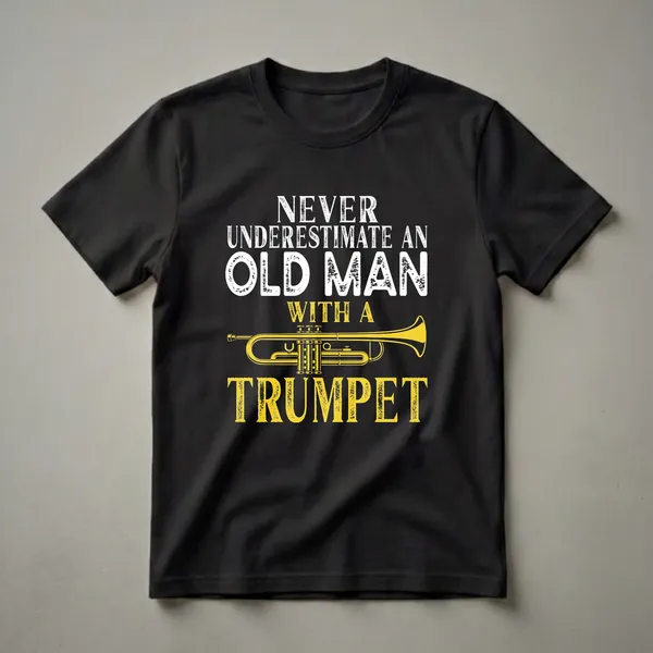 Black t-shirt with white distressed text reading 'NEVER UNDERESTIMATE AN OLD MAN' above a yellow trumpet illustration and yellow distressed text reading 'TRUMPET'.