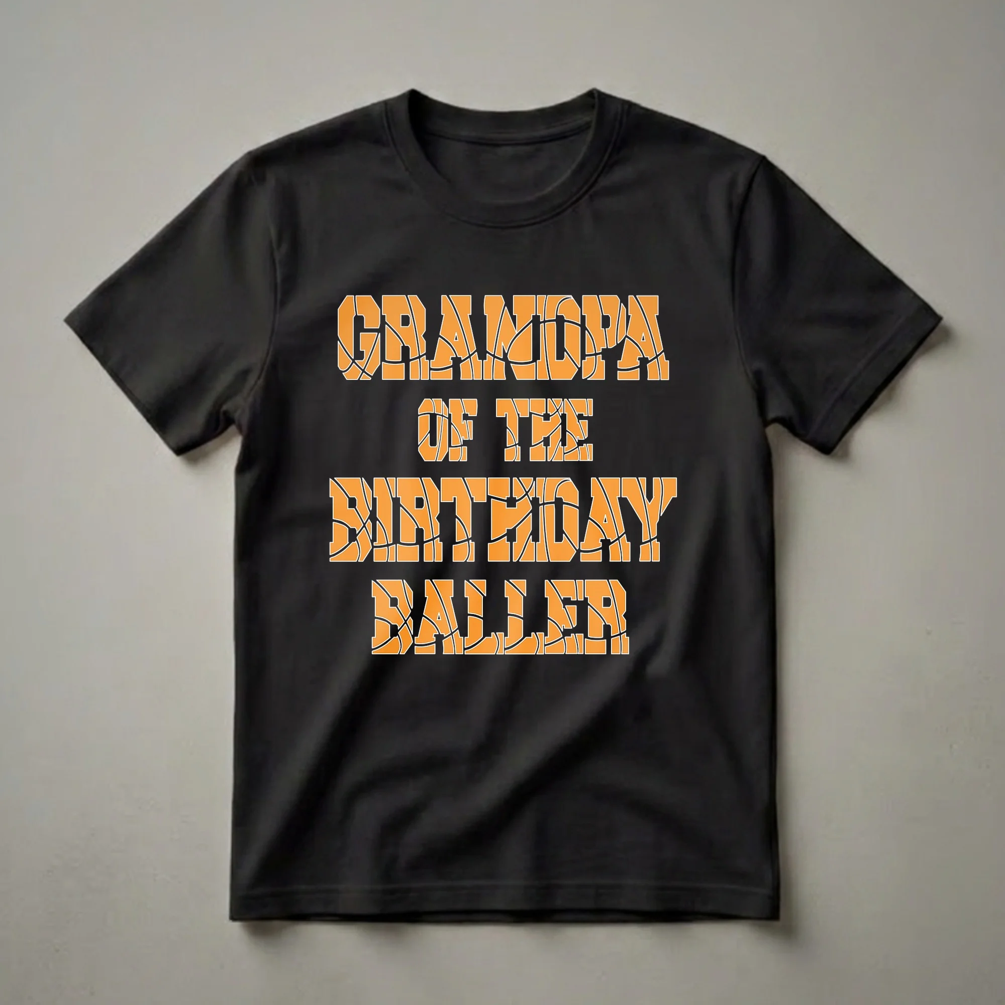 Black t-shirt with orange and white text that reads 'Grandpa Of The Birthday Baller', with the letters filled with a basketball pattern.