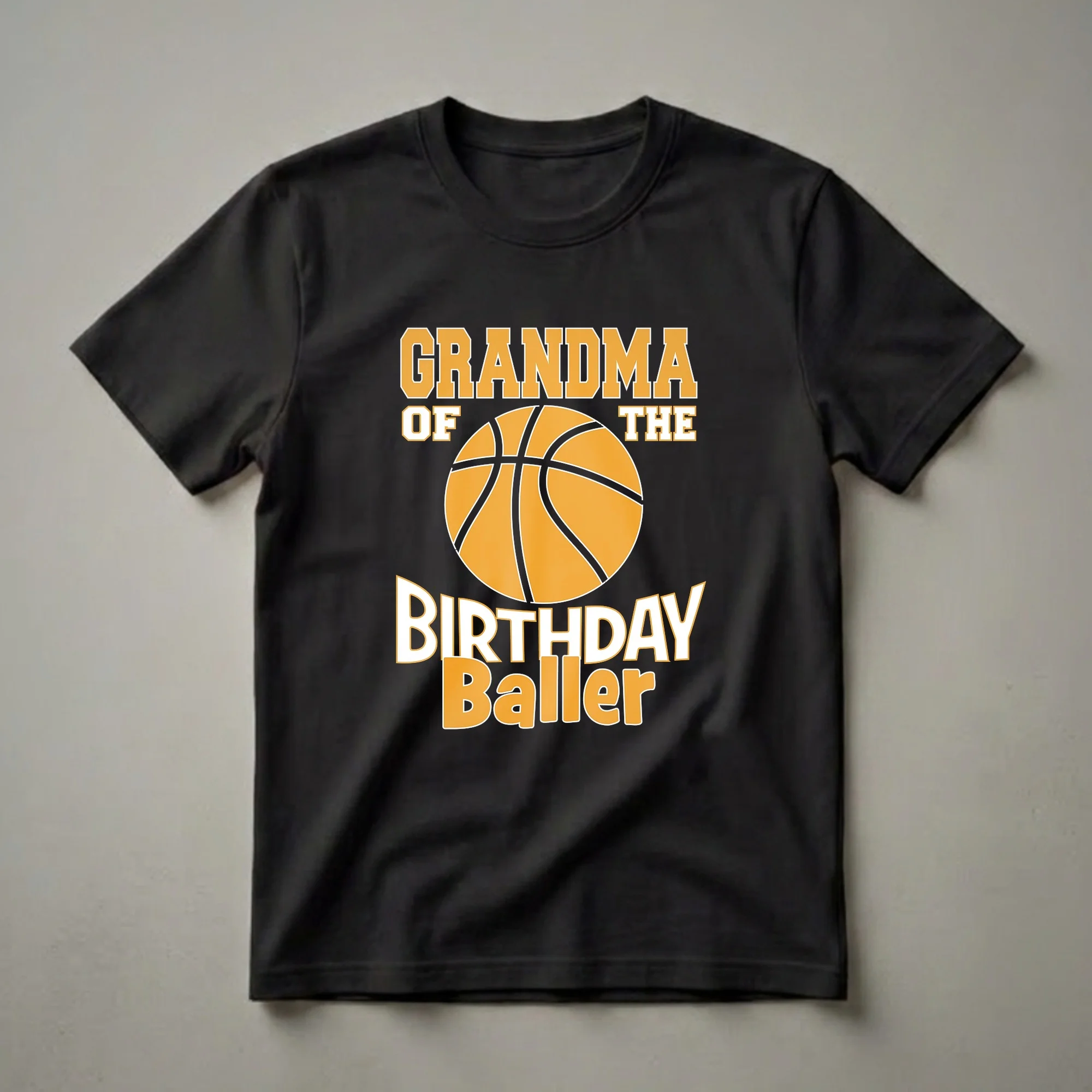 Black t-shirt with orange and white text reading "GRANDMA OF THE BIRTHDAY Baller" and a graphic of a basketball.