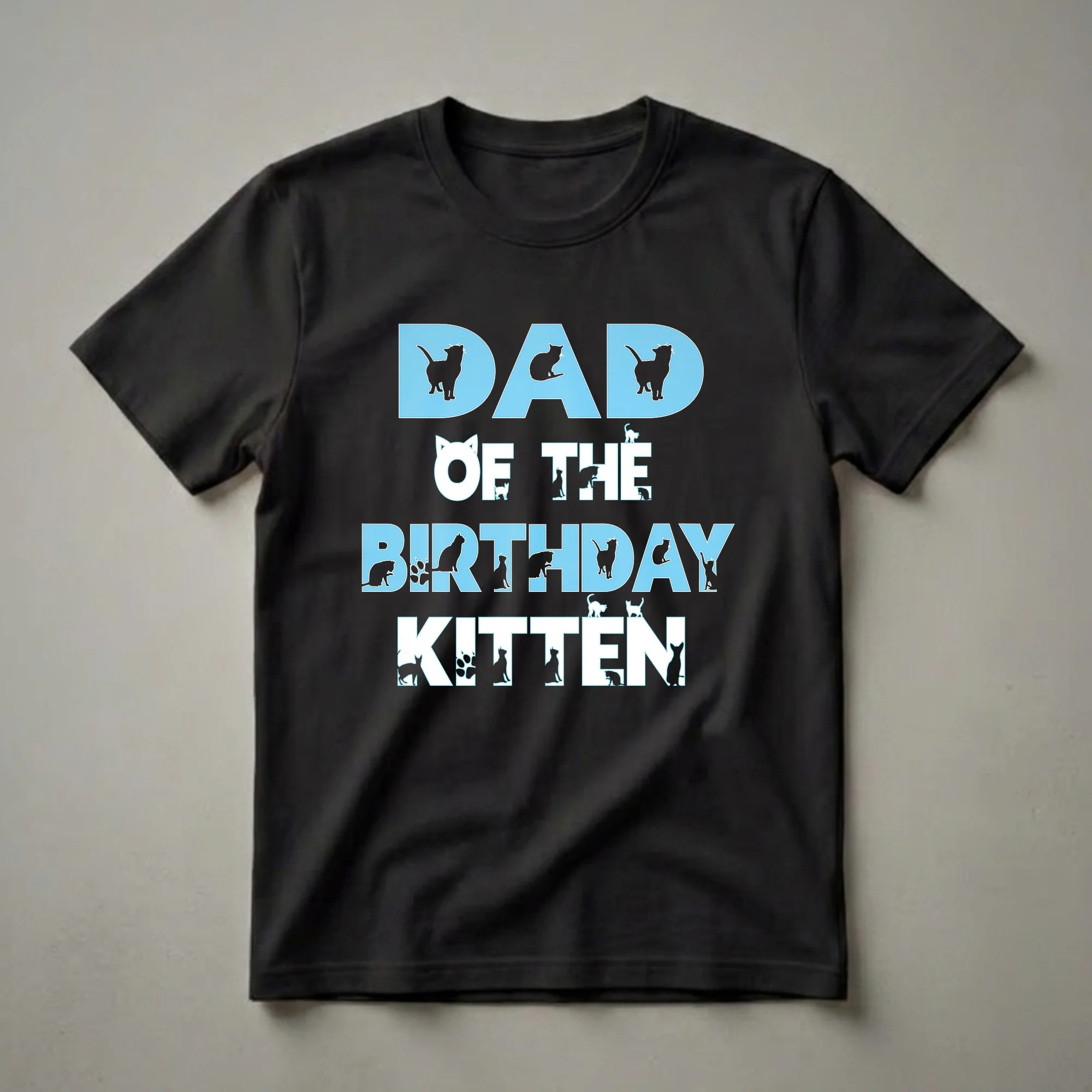 Black t-shirt with light blue and white text that reads "DAD OF THE BIRTHDAY KITTEN", featuring numerous cat silhouettes and paw prints integrated into the lettering.