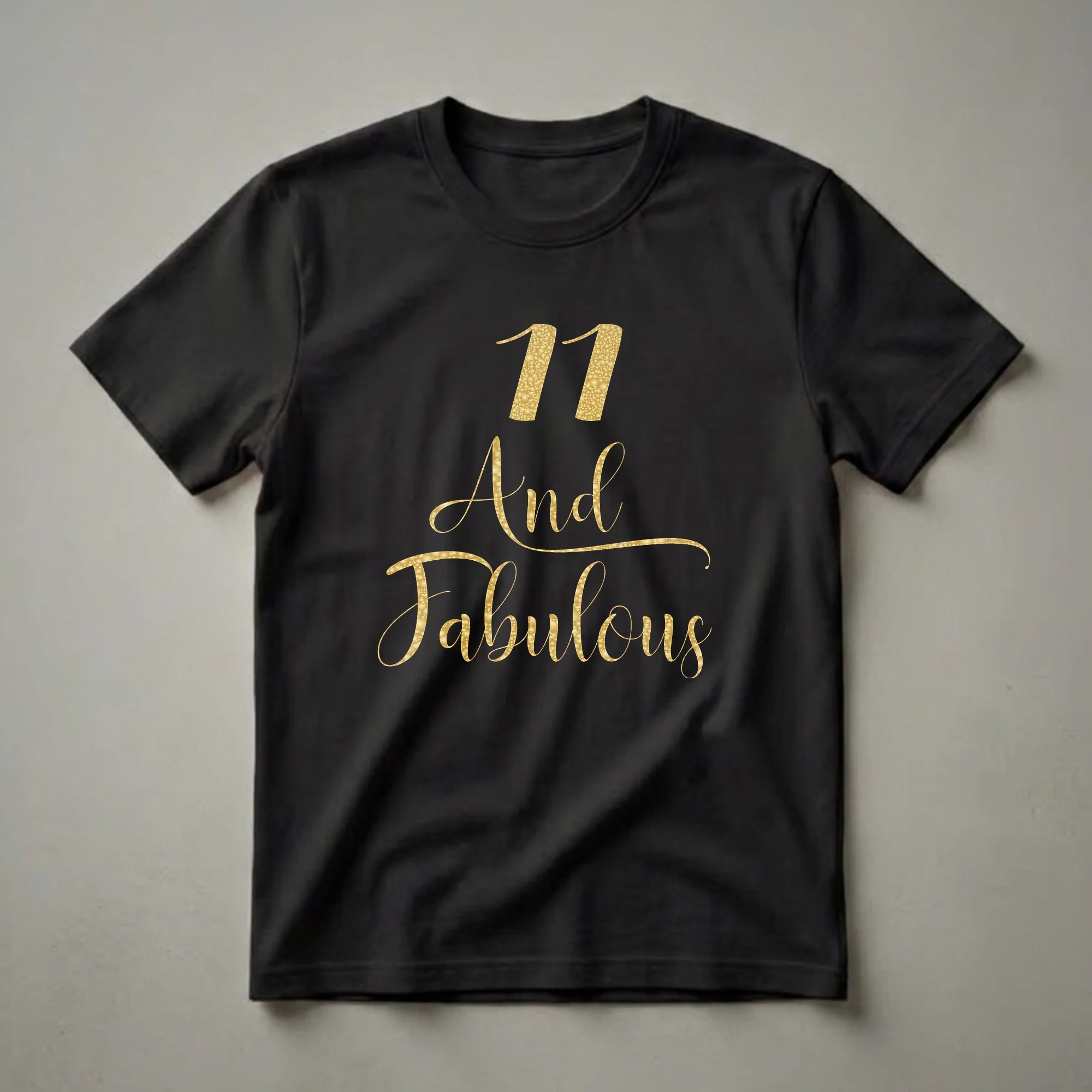 Black t-shirt with gold text that reads '11 And Fabulous' in a decorative font, celebrating an 11th birthday.