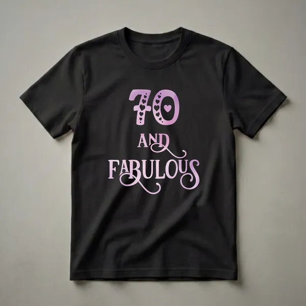 A black t-shirt graphic featuring the number 70 in a purple gradient with heart details, and the words "AND FABULOUS" below it in a script font.