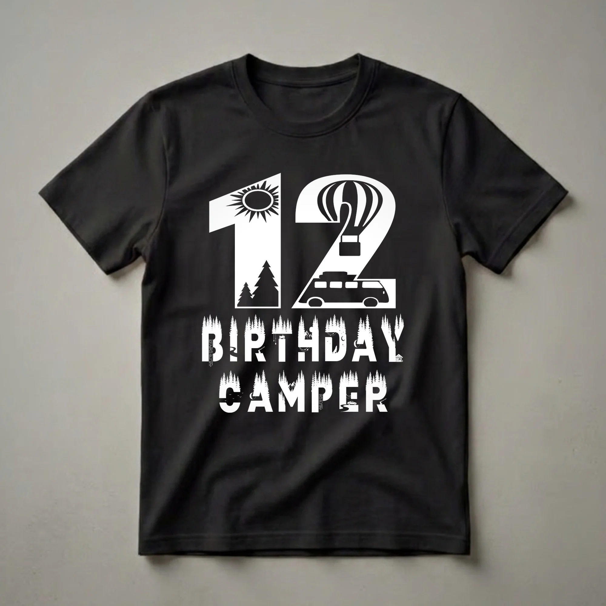 White graphic t-shirt with the number 12, a sun, a hot air balloon, a camper van, and the words 'BIRTHDAY CAMPER' filled with forest scenes, mountains, rivers, and wildlife.
