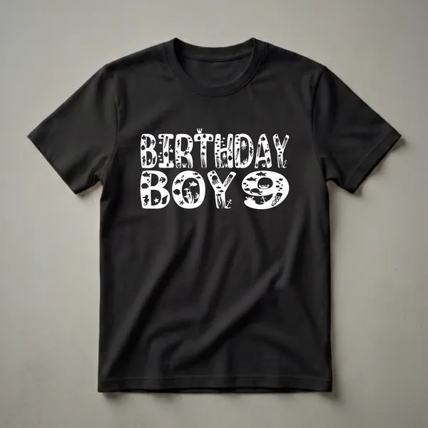 White graphic on a black t-shirt that reads 'BIRTHDAY BOY 9' with the letters filled with various sea creatures like fish, jellyfish, turtles, crabs, and anchors.