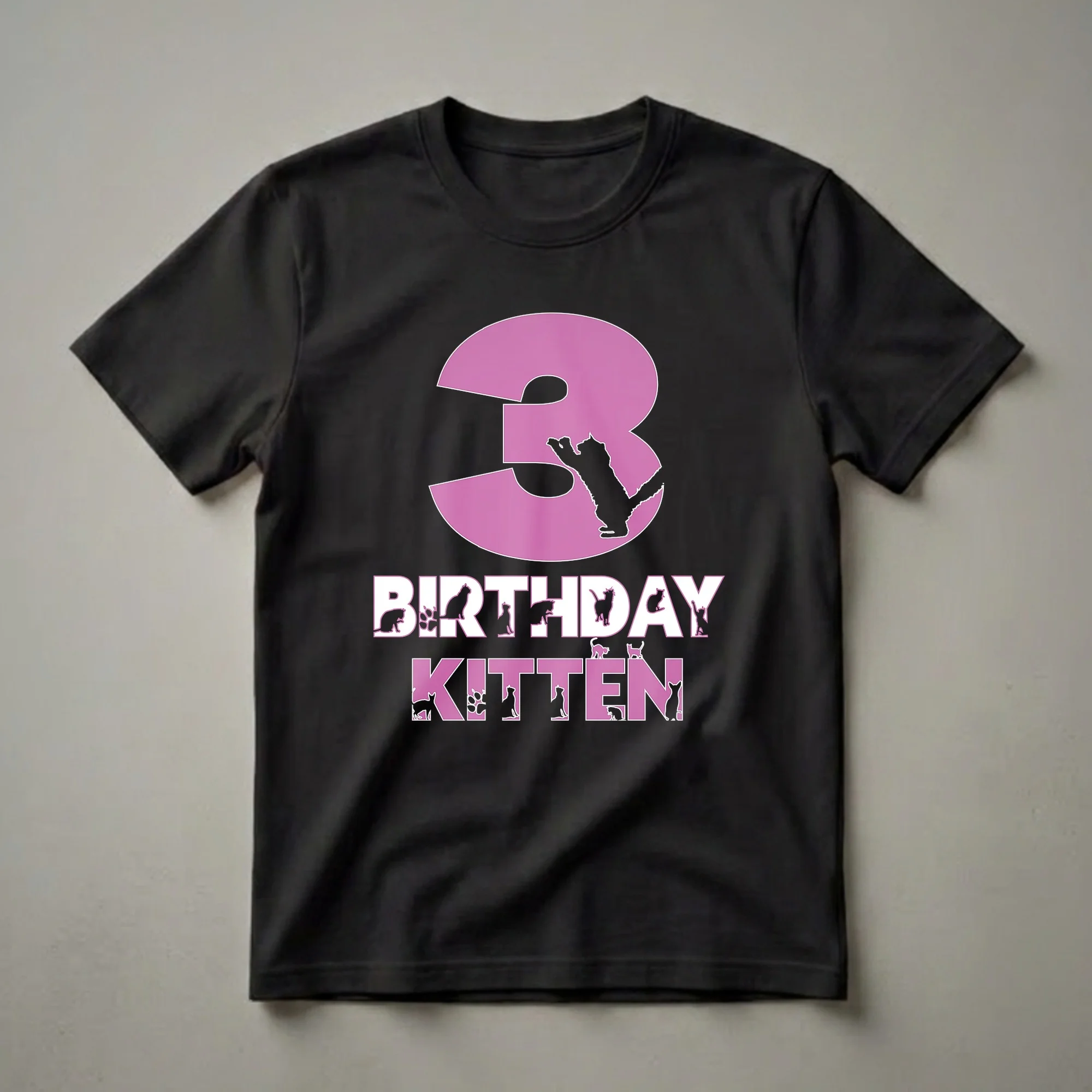 Black t-shirt with a large pink number '3' featuring a black cat silhouette, and the words 'BIRTHDAY KITTEN' below, with various cat and paw print silhouettes integrated into the letters.