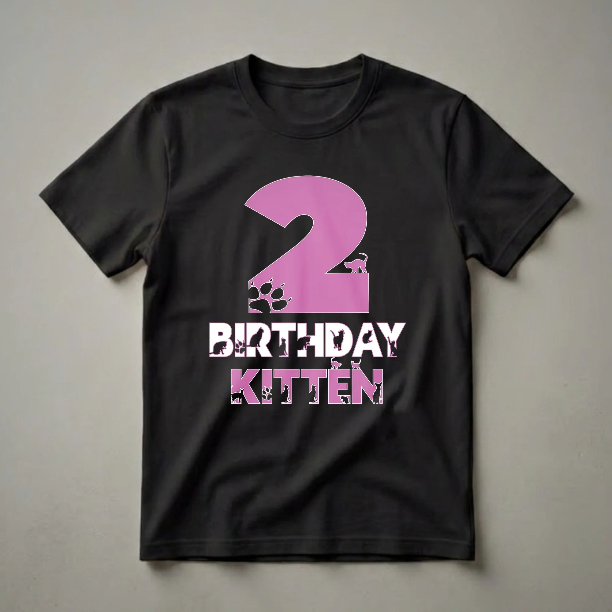 Pink graphic t-shirt with a large number '2' and the words 'BIRTHDAY KITTEN', featuring black cat silhouettes and paw prints, for a 2nd birthday celebration.