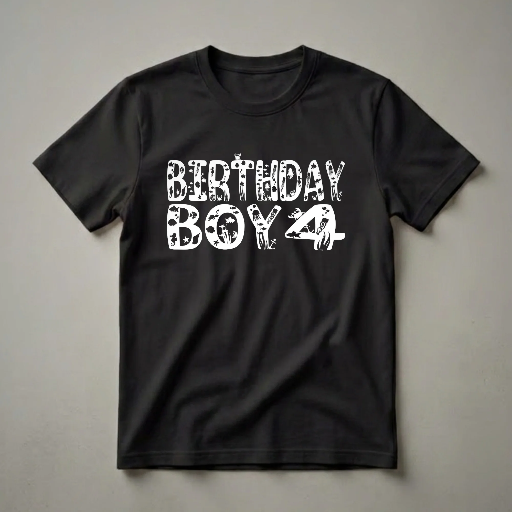 White graphic text that reads 'BIRTHDAY BOY 4' filled with various underwater marine life like fish, seahorses, jellyfish, octopuses, crabs, and anchors, set against a black background.