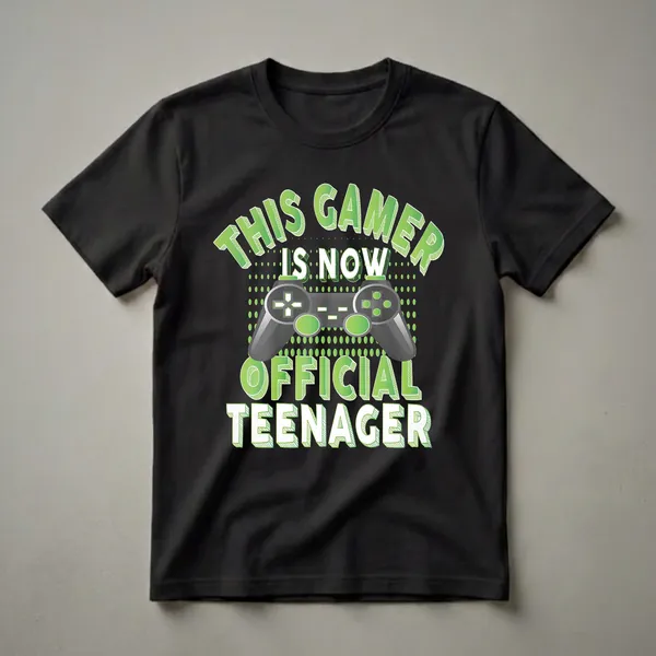 Black t-shirt with green and white text that reads 'THIS GAMER IS NOW OFFICIAL TEENAGER' and a graphic of a video game controller.