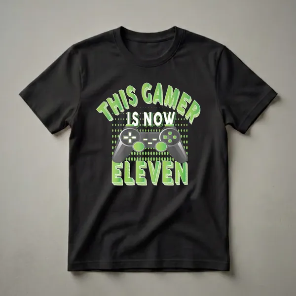 Black t-shirt with green text that reads 'This Gamer Is Now Eleven' and features a graphic of a video game controller.
