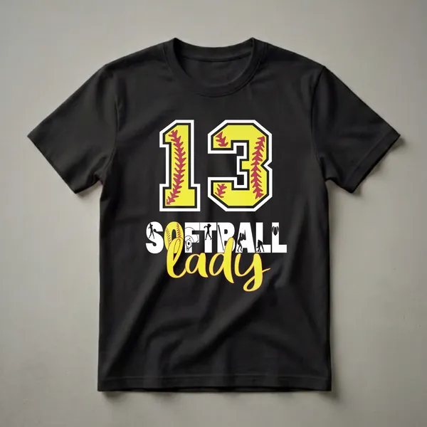 Black t-shirt featuring a large yellow '13' with red softball stitching, and the words 'SOFTBALL LADY' below, surrounded by softball player silhouettes and imagery.