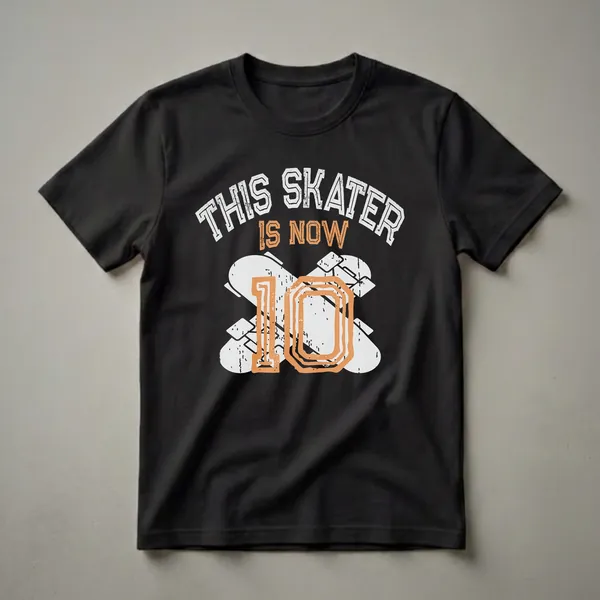 Black t-shirt with distressed white and orange graphic text that reads 'THIS SKATER IS NOW 10' with abstract shapes and skateboard elements.