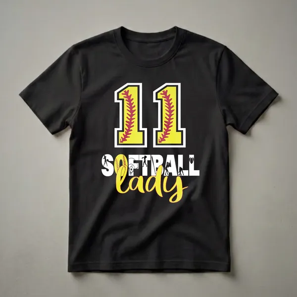 Black t-shirt with yellow and red '11' filled with softball stitching, and white and yellow 'SOFTBALL LADY' text with softball player silhouettes and a softball heart.