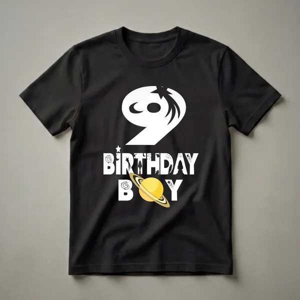 Black t-shirt with a white graphic design that includes the number 9, the words BIRTHDAY BOY, stars, moons, rockets, and a planet with rings.