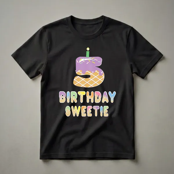 A graphic t-shirt design featuring a purple frosted waffle cake shaped like the number 5 with a green candle, and the words BIRTHDAY SWEETIE in colorful dripping letters.