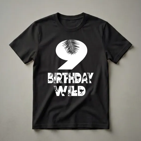 Black graphic t-shirt with a large white number 9 overlayed with a palm frond, and the words BIRTHDAY WILD filled with silhouettes of zoo animals and tropical leaves.