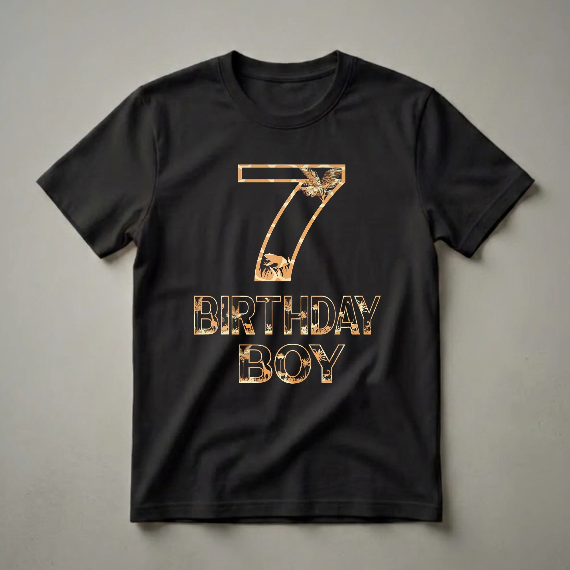 A black t-shirt graphic featuring the number 7 and the words BIRTHDAY BOY, filled with silhouettes of jungle animals like giraffes, lions, and deer, along with palm trees.