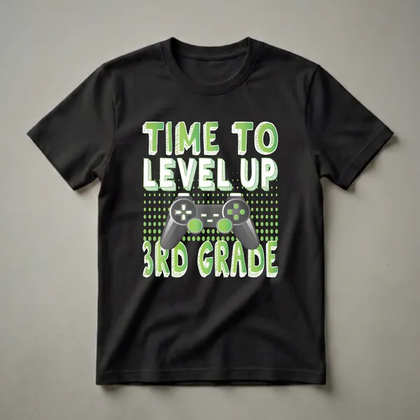 Black t-shirt with green and white text reading 'TIME TO LEVEL UP' and '3RD GRADE' surrounding a grey video game controller graphic.