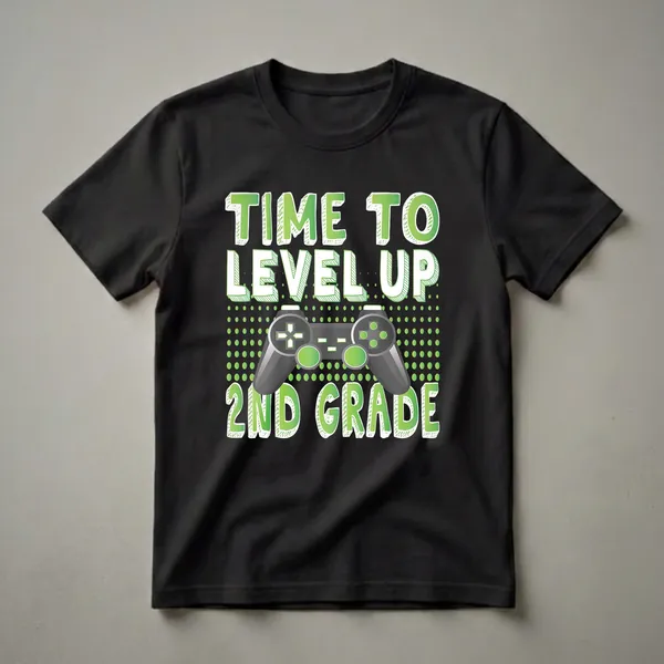 Black t-shirt with green text 'TIME TO LEVEL UP' and '2ND GRADE' surrounding a gray video game controller with green accents.