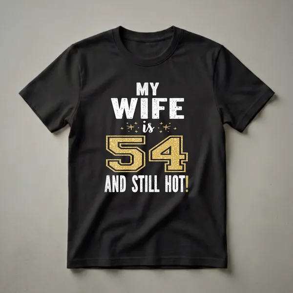 Black t-shirt with white distressed text reading 'MY WIFE' and 'AND STILL HOT!', and a large gold glitter-filled number '54' with small gold star accents.