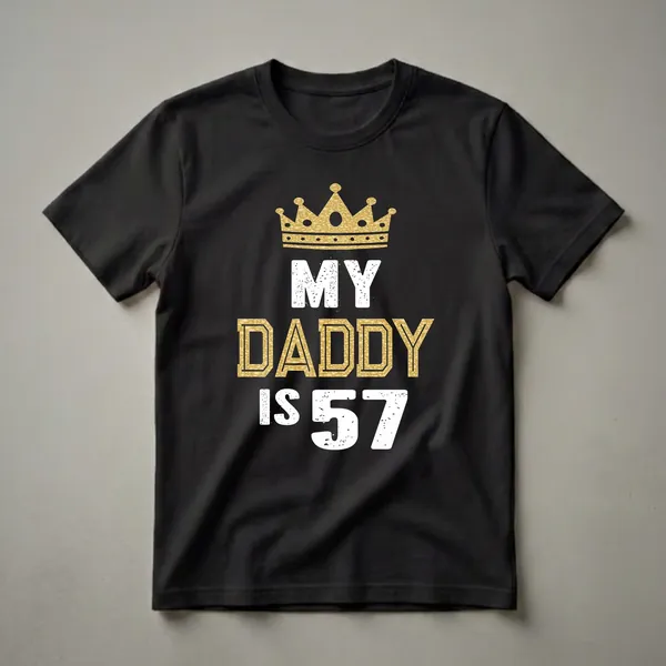 Black t-shirt with a gold glitter crown and white and gold distressed text that reads 'MY DADDY IS 57'.