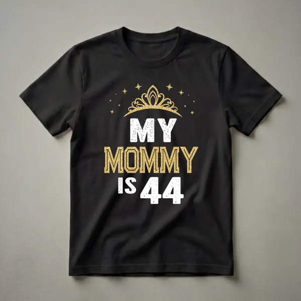 Black t-shirt with white distressed text 'MY' and 'IS 44', and gold textured text 'MOMMY', topped with a gold crown and surrounded by gold stars.