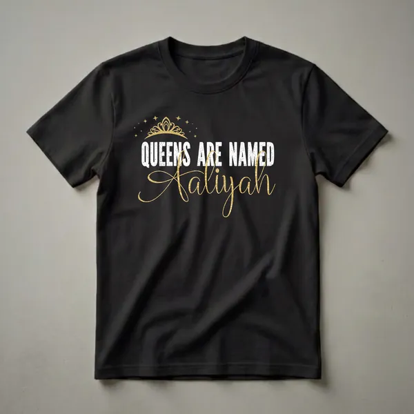 Black t-shirt with white distressed text 'QUEENS ARE NAMED' and gold script text 'Aaliyah', topped with a gold crown and stars.
