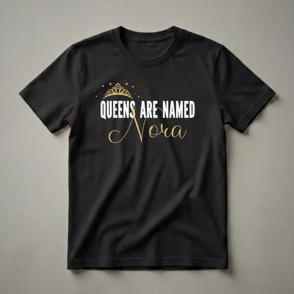 Black graphic t-shirt with distressed white text 'QUEENS ARE NAMED' and gold script text 'Nora', topped with a gold crown and stars.