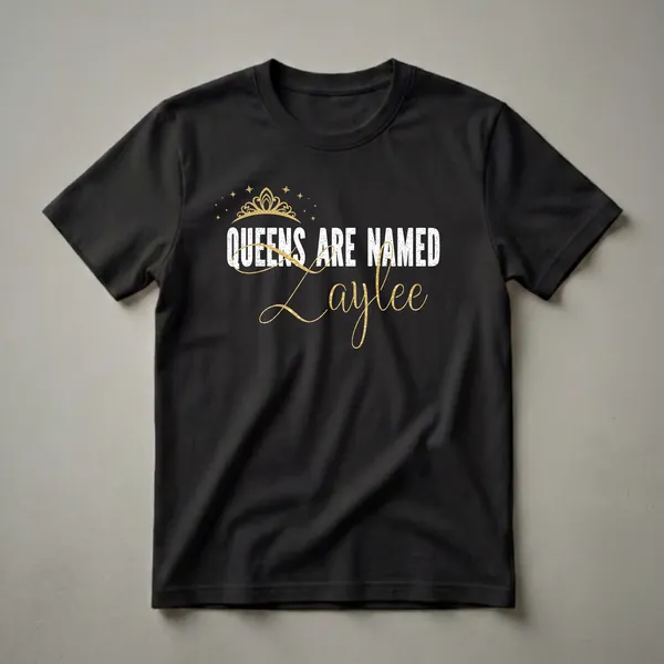 Black t-shirt with white distressed text 'QUEENS ARE NAMED' and a golden script name 'Zaylee', topped with a golden crown and scattered stars.