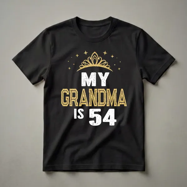Black t-shirt with white and gold text that reads 'MY GRANDMA IS 54' and a golden crown with stars above.