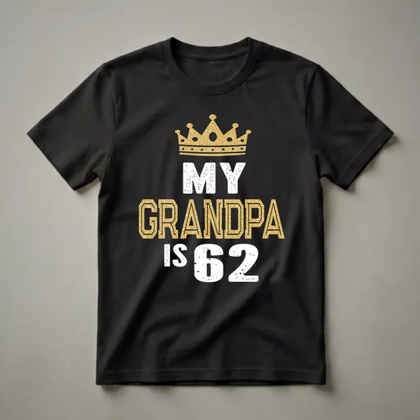 Black t-shirt with a gold glitter crown and distressed white text 'MY' above large gold glitter text 'GRANDPA IS 62'.