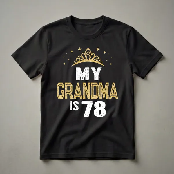 Black t-shirt with white and gold distressed text that reads "MY GRANDMA IS 78" and features a golden crown and stars at the top.