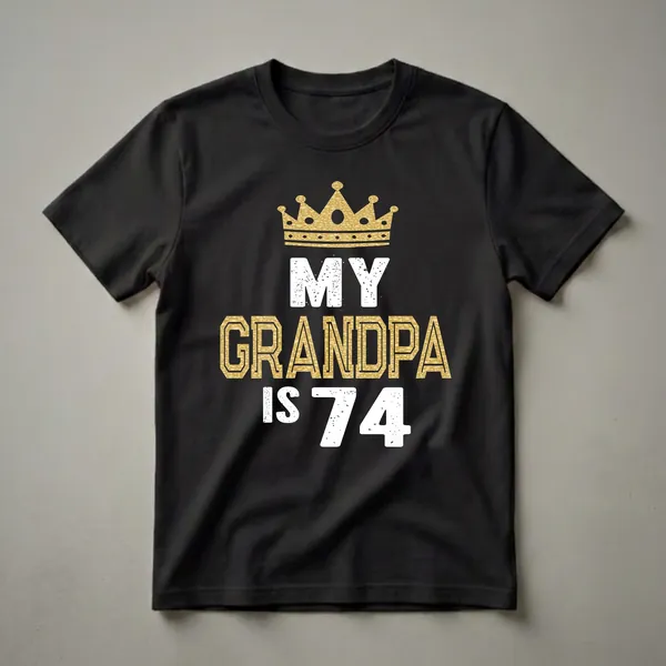 Black t-shirt with a gold crown graphic and white text that reads 'MY GRANDPA IS 74', celebrating a 74th birthday.