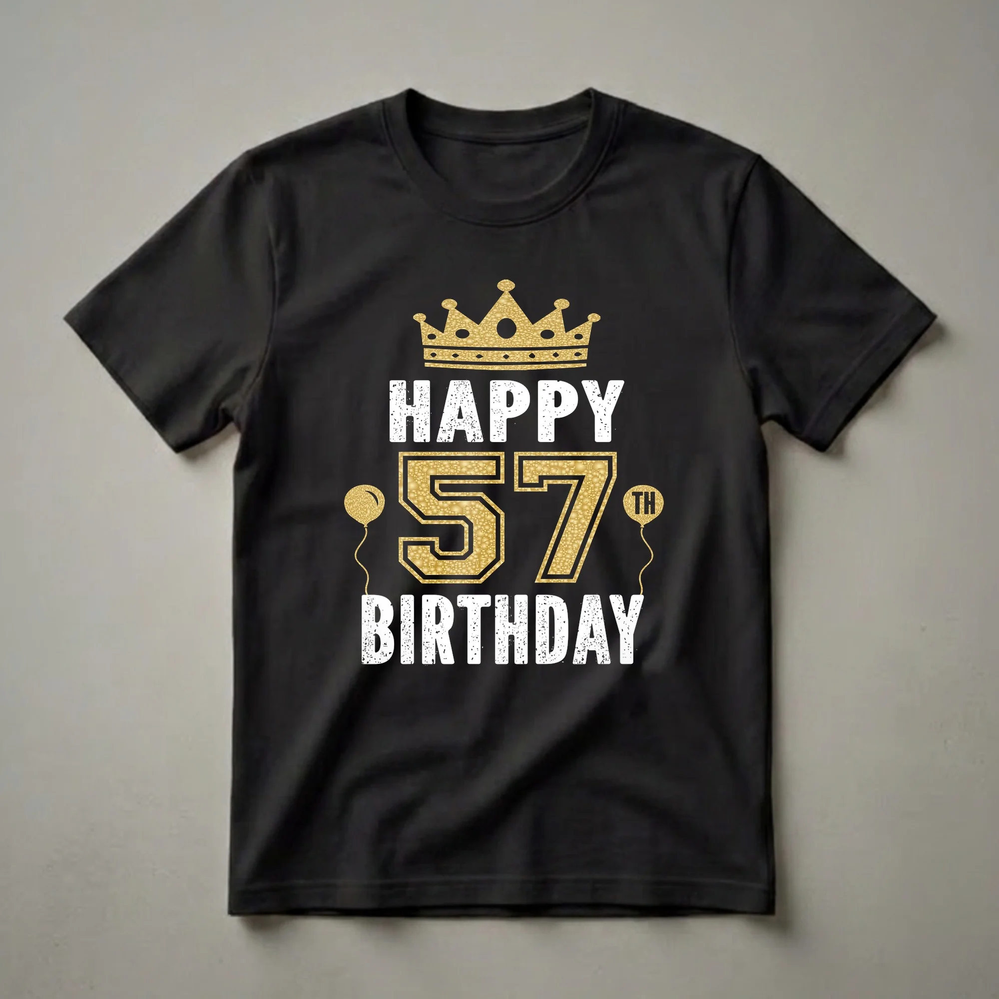 Black t-shirt with a gold crown, gold number 57 with textured fill, and white distressed text reading 'HAPPY BIRTHDAY' and 'TH' on a balloon.