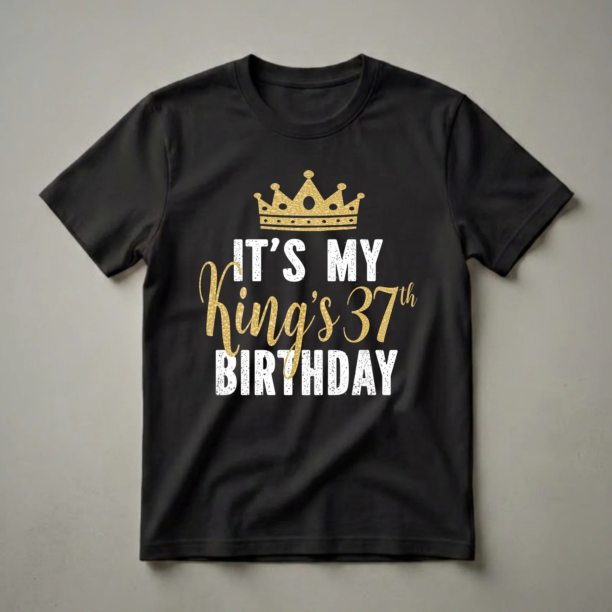 Black t-shirt with a gold crown graphic and distressed white and gold text that reads 'IT'S MY King's 37th BIRTHDAY'.