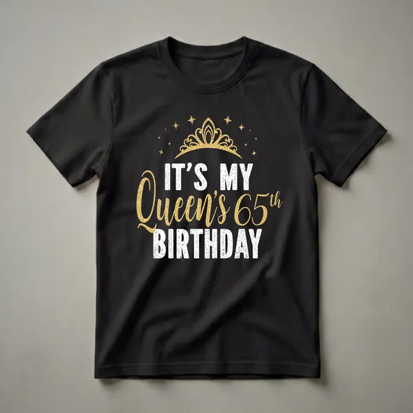 Black t-shirt with a gold crown and stars graphic, featuring white and gold text that reads 'IT'S MY Queen's 65th BIRTHDAY'.