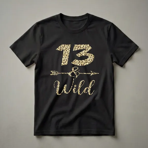 Black t-shirt with "13 and Wild" text and an arrow graphic, all filled with a leopard print pattern.
