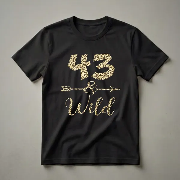 A black t-shirt featuring the number 43 and the word "Wild" in leopard print, with an arrow and ampersand graphic in between.