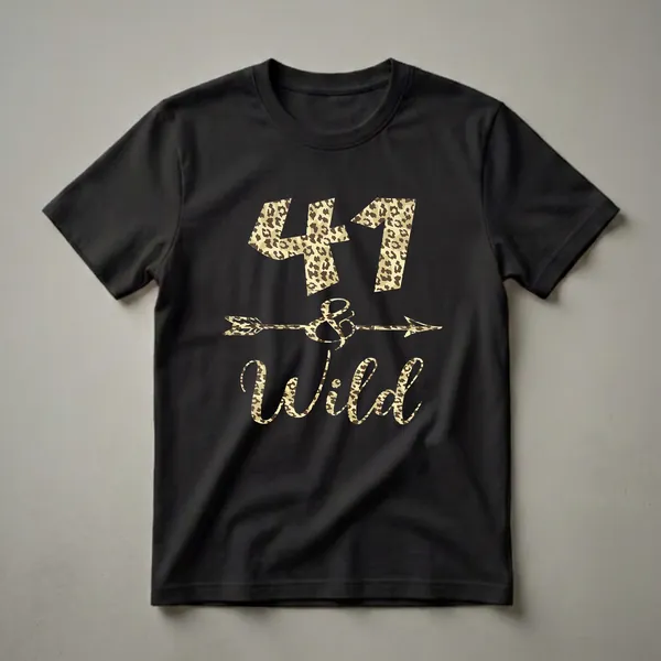 Black t-shirt with "41 & Wild" graphic design in leopard print, featuring the number 41, an ampersand with an arrow, and the word Wild.
