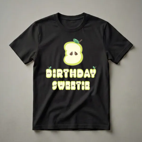 A black t-shirt graphic featuring a sliced green apple forming the number 3, with the words BIRTHDAY SWEETIE below, also styled as apple slices.