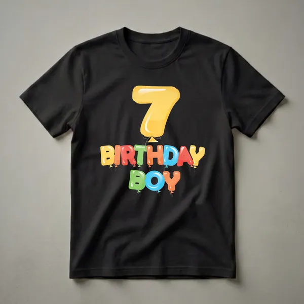 A graphic t-shirt design featuring a large yellow balloon number 7 above colorful balloon letters spelling "BIRTHDAY BOY" on a black background.
