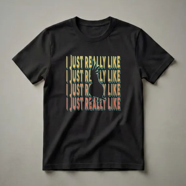 Black graphic t-shirt with the phrase 'I JUST REALLY LIKE' repeated in retro font and a black silhouette of a cockatoo bird in the center.