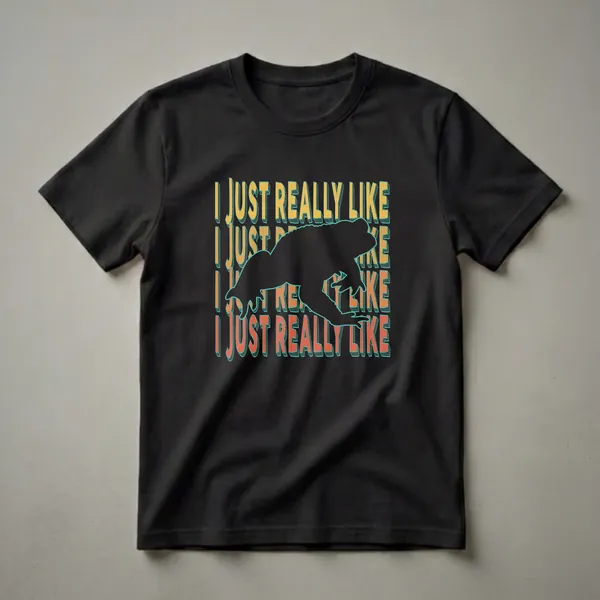 Black graphic t-shirt featuring a frog silhouette with repeating text that says 'I Just Really Like' in yellow and orange.