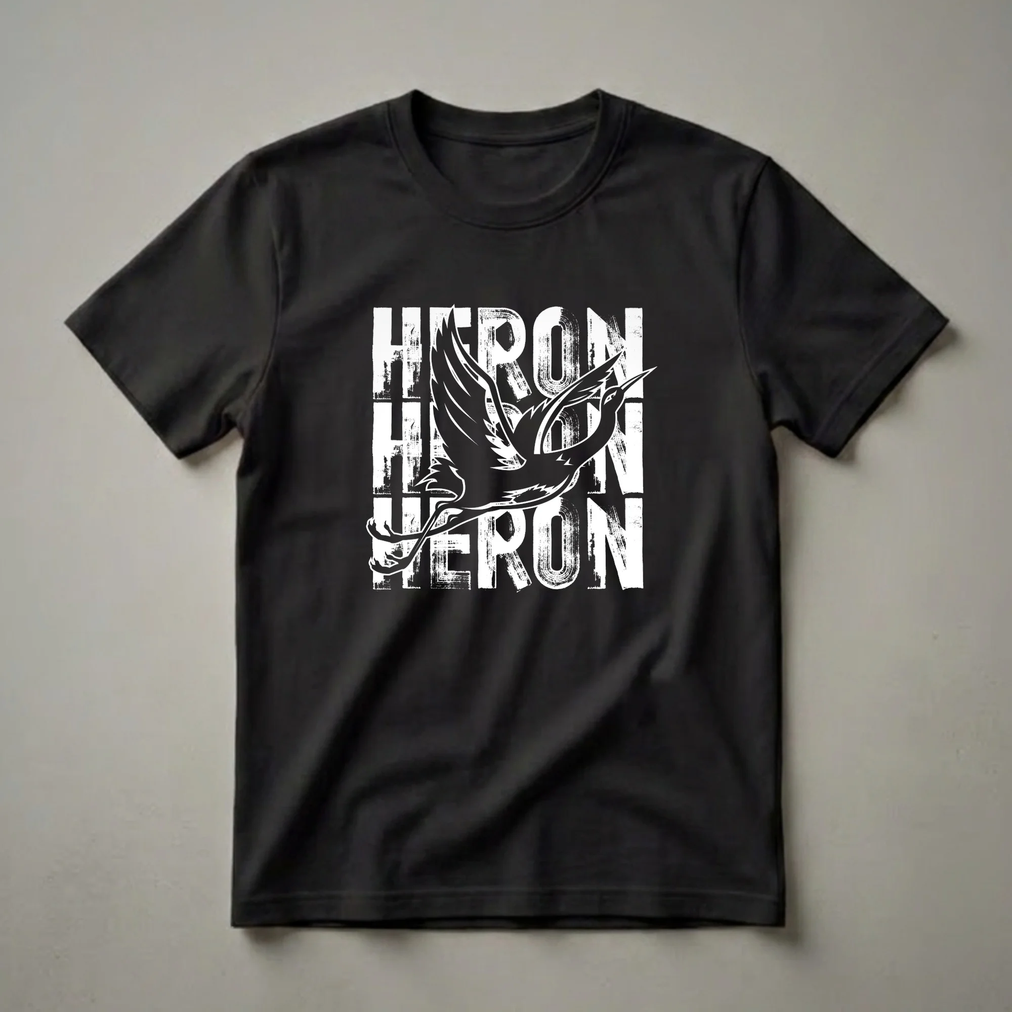 Black t-shirt with a white graphic of a flying heron bird superimposed over distressed white text spelling "HERON".