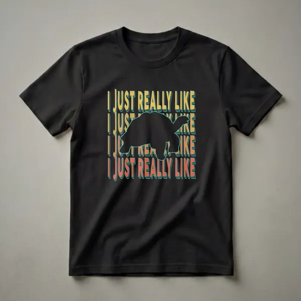 Black t-shirt with the phrase "I Just Really Like" repeated in yellow, orange, and teal, overlaid with a black silhouette of a turtle.